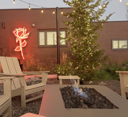 View of Hotel Melrose's Patio with Fireplace Lit
