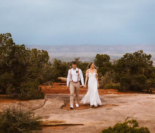 A recently married couple walking in Colorado National Monument