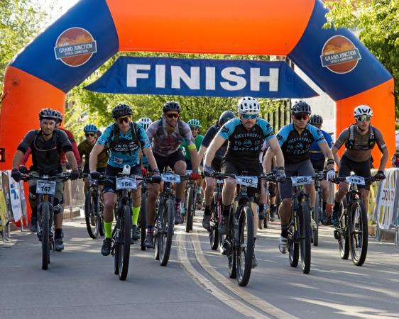 Picture of People Crossing the Finish Line in a Bike Race