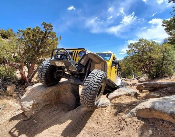 Picture of Yellow Jeep Driving Over Big Rock