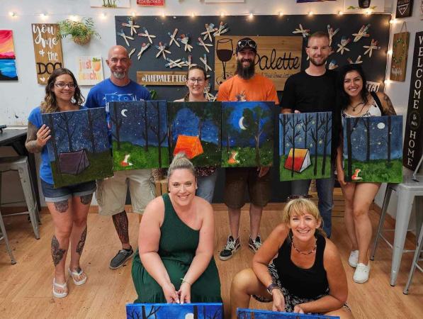 People Holding Paintings at The Palette