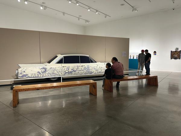 Visitors view a lowrider car at the National Hispanic Cultural Center