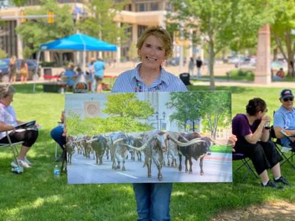 Dorinda Blease, winner of the 2021 CCC Cattle Drive PHoto contest holding the winning photo she took