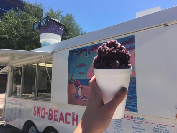 Grape sno cone in front of the Sno-Beach trailer