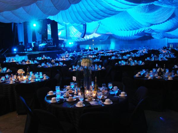 Meeting Room With Blu Ornaments and Tables Set Up With Plates And Silverware