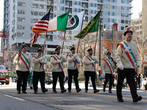 Men with flags walking in the Downtown Columbus St. Patrick's Day Parade