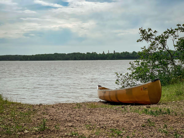 A canoe sitting on a bank