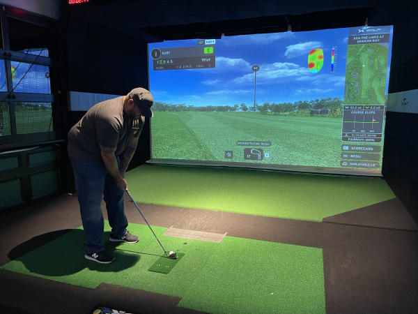 A golfer prepares to take a swing at X-Golf Lehigh Valley