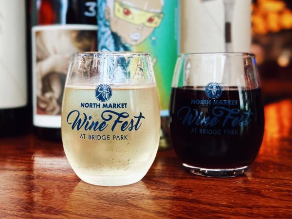 North Market Wine Fest stemless wine glasses filled with a red and a white wine.
