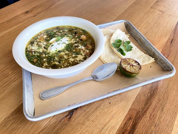 Bowl of green chili with tortillas