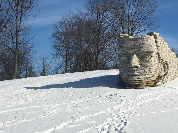 Leatherlips stone sculpture during the winter with snow on the ground.