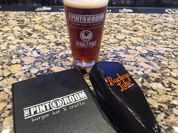 A Pint glass, Buckeye Lake tap handle and The Pint Room menu.