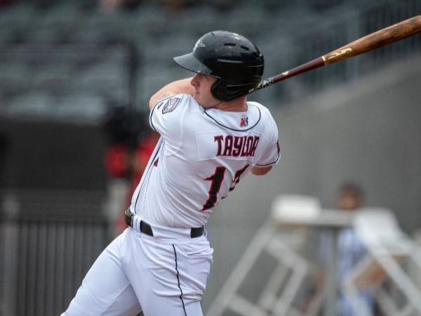 A professional baseball player swinging at bat from Phoenix Bats in Plain City, Ohio.