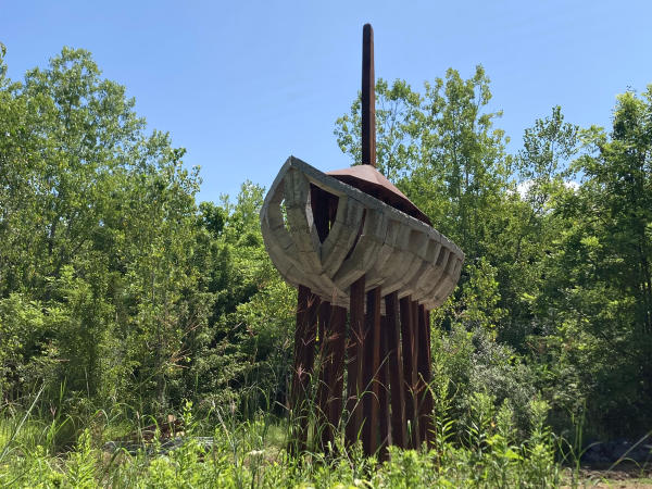 A giant wooden boat supported by beams in the air.