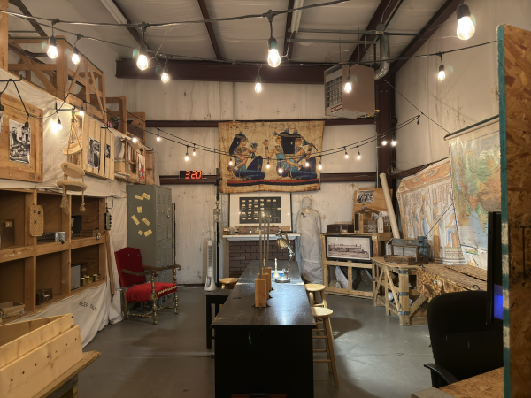 Maps and flags of Egyptian hieroglyphics hang from the walls while stringed lights hang wall to wall at the Fort Smith Escape Room.