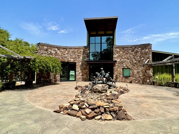 A wide angle shot displays the entrance to the Janet Huckabee Nature Center in Fort Smith, Arkansas.