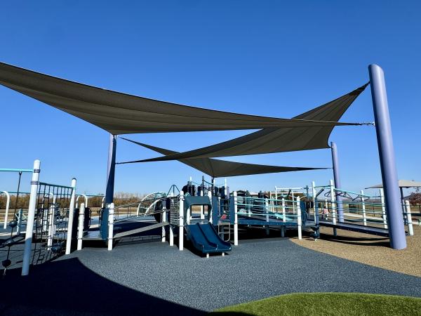 Cabanas shade the play equipment on a sunny day with perfectly clear skies at John Bell Jr. Park in Fort Smith, Arkansas.