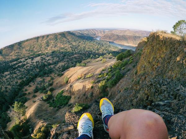 Man enjoying view of trees and river on a mountain top