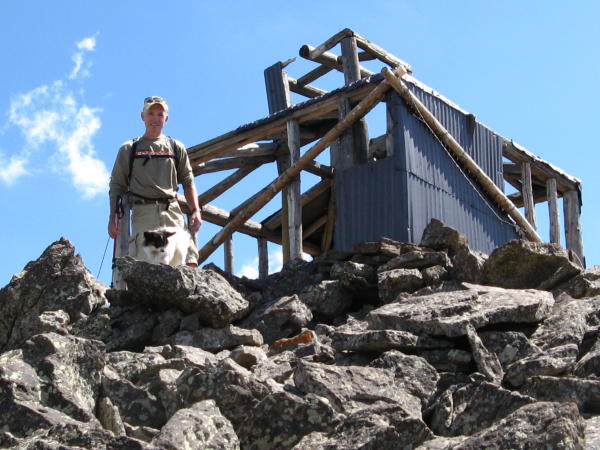 Man Standing Next to Leon Peak Fire Structure