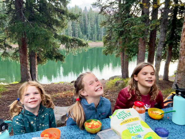 Three Kids Eating at a Picnic Table on the Grand Mesa