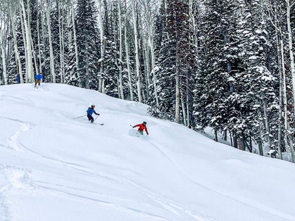 three people skiing downhill at Powderhorn Mountain Resort