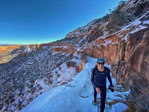 Woman walking along Colorado National Monument in Snow