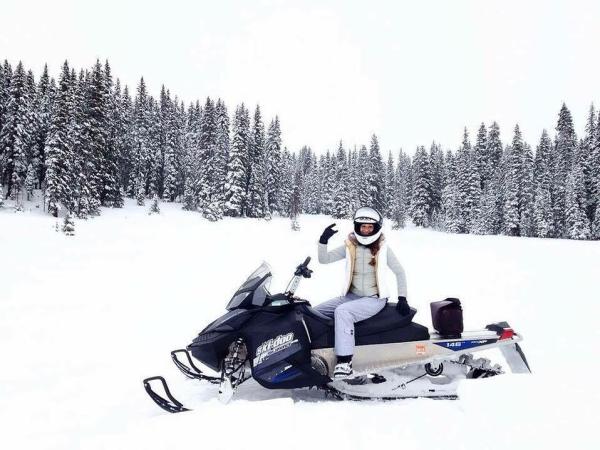 Woman on a snowmobile on the Grand Mesa