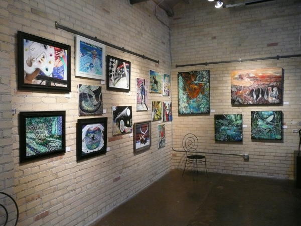 Art hanging on brick wall at Art Garage