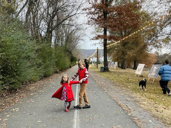 Two kids play on a walking path