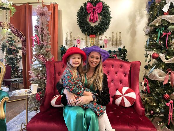 Woman and little girl sit in a red chair