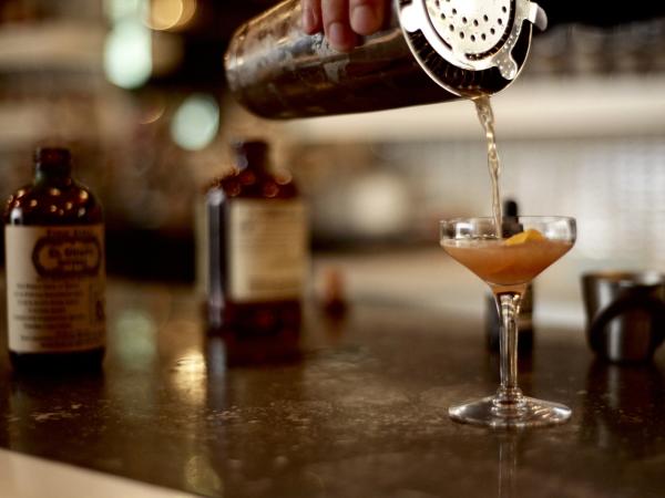 cocktail being poured into a glass