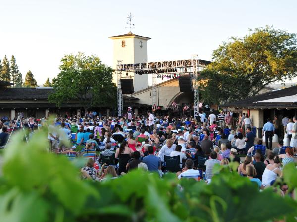 People sitting on the lawn and chairs at a Robert Mondavi Summer Concert