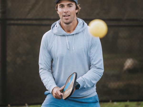 A man playing pickleball