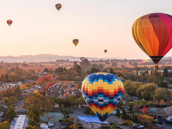 hot air balloons over the town of Yountville