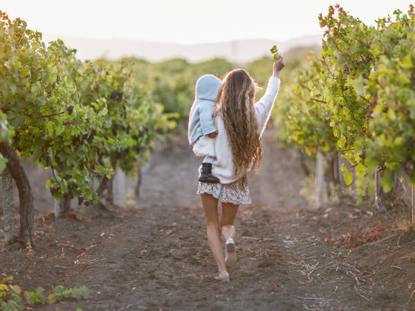 mom and kid in a vineyard