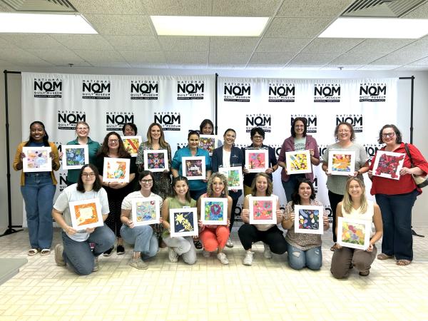 Adults pose with quilt squares at National Quilt Museum in Paducah, Kentucky.