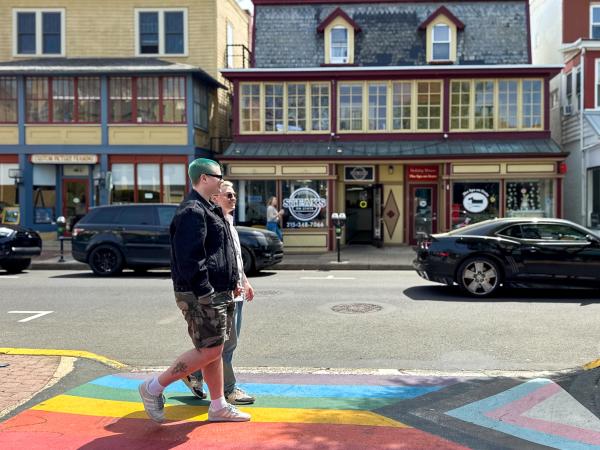 Couple walks across a crosswalk in a small town