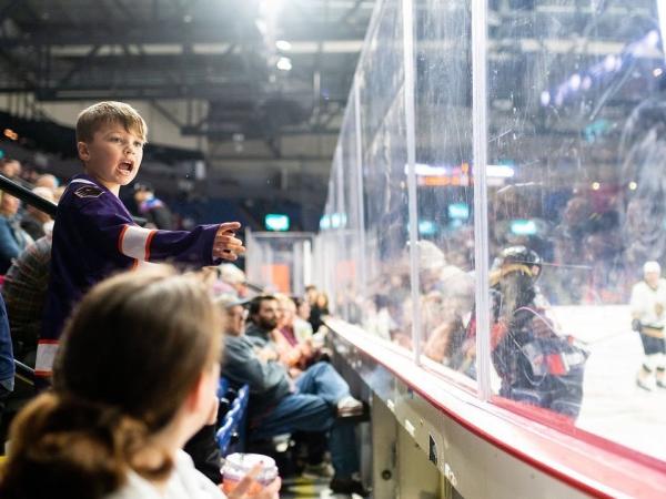 Child cheering at the royals hockey game