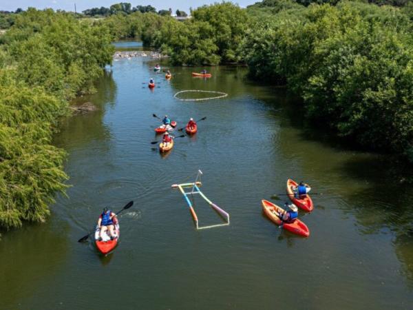 women kayakign on river