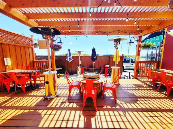 Private dining outdoor patio at 7 Mile House equipped with umbrellas and heaters