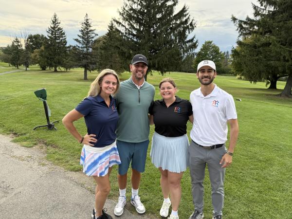 Liz, Eric, Bridget, Paul all participating in a golf tournament