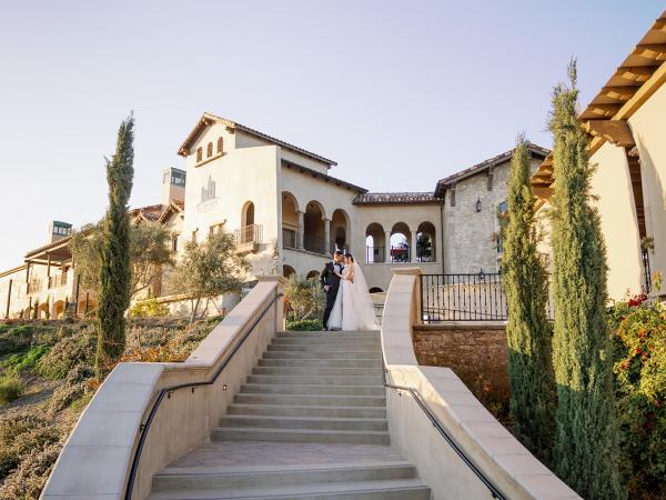 Bride and groom at the top of the stairs at Europa Village