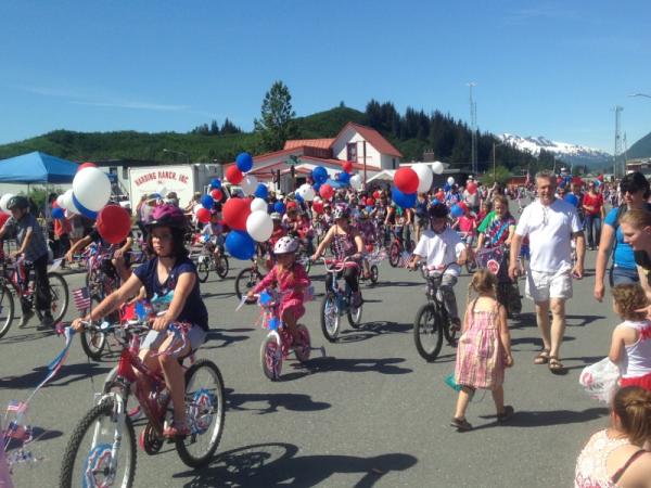 people ride bikes through Valdez, Alaska in summertime