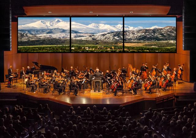 Image of the fort collins symphony playing with rocky mountains in the background