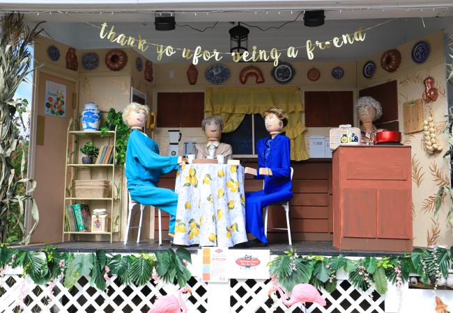 Diorama featuring scarecrows sitting at a dining room table during Return of the Pumpkin People