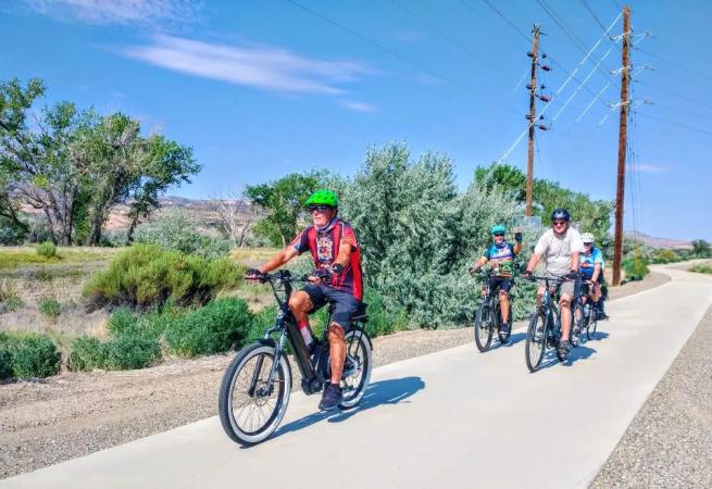 group of bikers biking near the Colorado National Monument