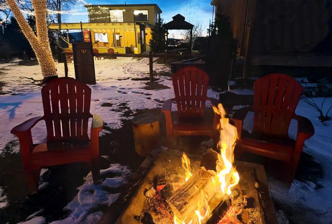 Firepit with Snow in Background of Highlands Distillery