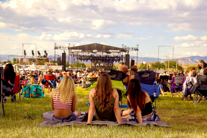 Three Women Sitting and Watching concert at Country Jam Colorado