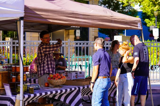 Man at Peach Stand During Market on Main in Downtown Grand Junction