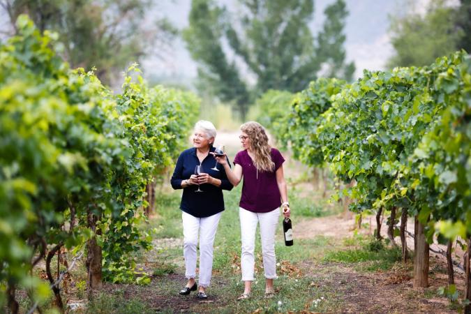Two Women Walking through Vineyards at Two Rivers Winery